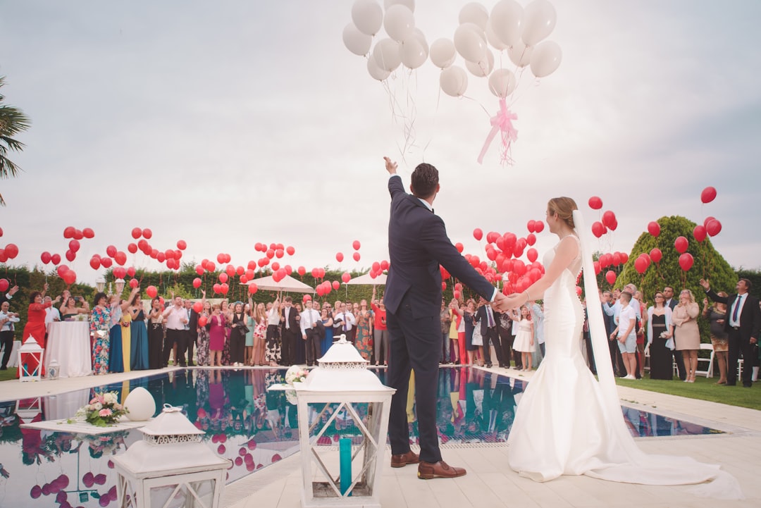 Photo by Álvaro CvG photo of a man and woman newly wedding holding a balloons